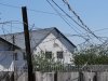 Бараки для содержания заключенных за забором колонии