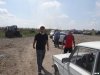 Охрана выправаживает автомобиль экологов за территорию полигона