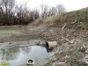 Дамба через старицу реки Кубань, построенная в целях проезда к элитному посёлку на Зелёном острове