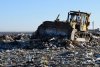 Бульдозер утрамбовывает всё новые слои мусора на Динской свалке