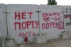 Надписи протеста местных жителей на заборе строящегося порта